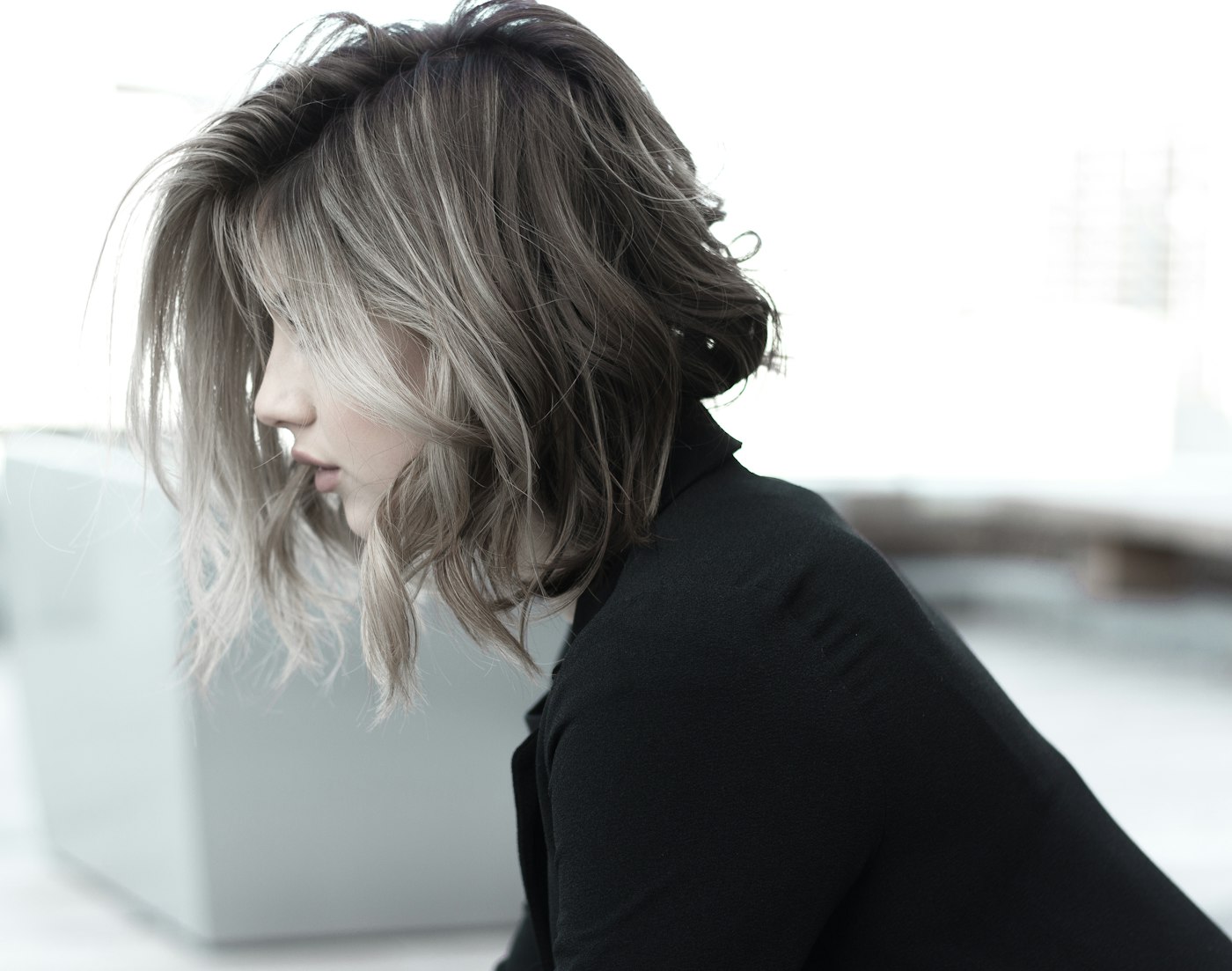 A soft blonde bob, photographed in profile.